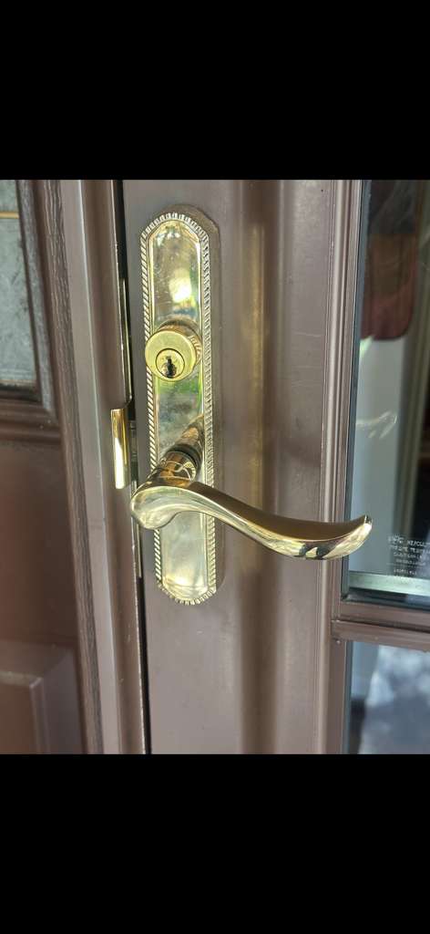 Locksmith rekeying a residential deadbolt in Flagler Estates FL