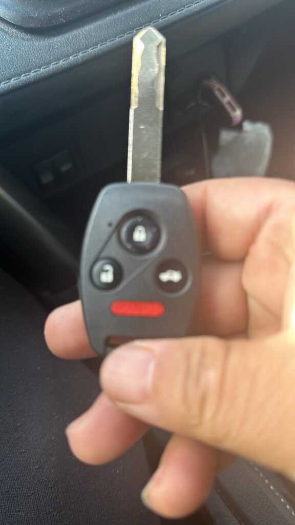 Locksmith cutting a replacement car key on site in St. Johns County